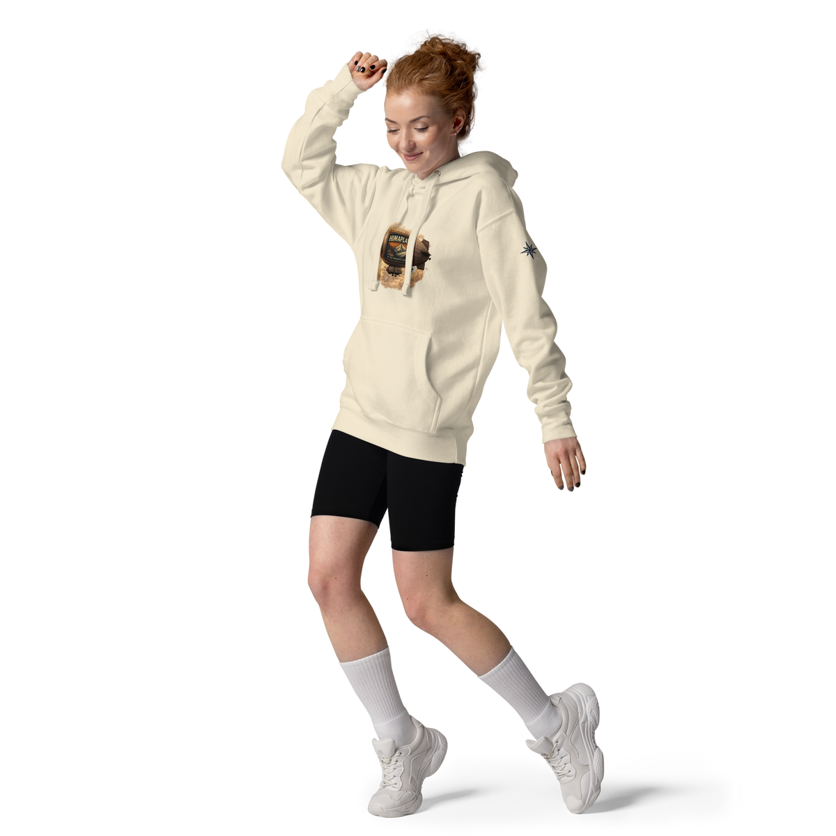 Woman wearing a pink HIMAPLAYA hoodie, black shorts, white socks, and white sneakers on a white background